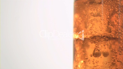 Ice bubbling in super slow motion in apple juice