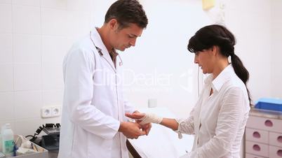 Doctor doing a bandage at patient wrist