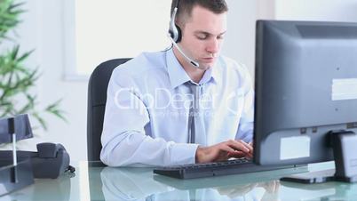 Businessman picking up while holding a headset