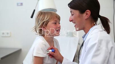 Doctor taking temperature of a child