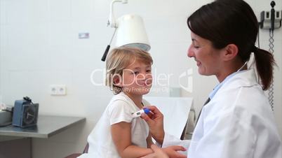 Doctor taking temperature of a child