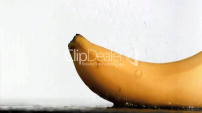 Delicious banana in super slow motion receiving water