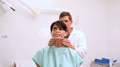 Doctor auscultating the neck of his patient