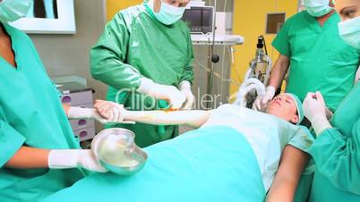 Surgeon disinfecting forearm of a patient