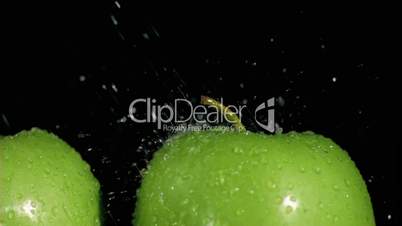 Green apples watered in super slow motion
