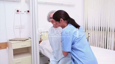 Nurse assisting an elderly patient