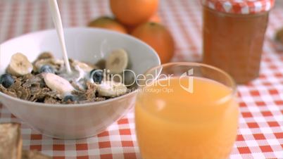 Milk flowing in super slow motion in cereals