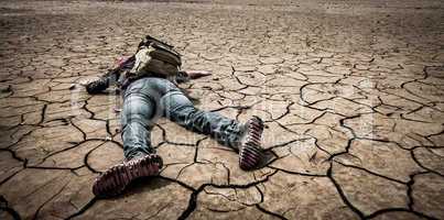 person lays on the dried ground