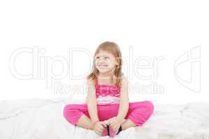 Portrait of a cute little girl sitting on floor, isolated over w