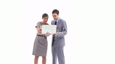 Business people holding a laptop while talking