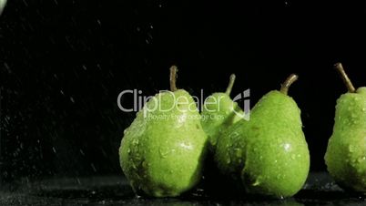 Green pears in super slow motion being soaked