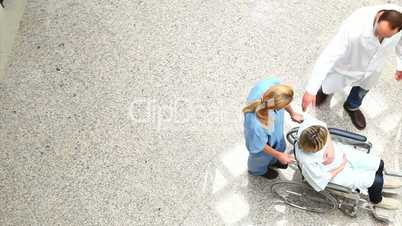 High angle view of a nurse wheeling a patient in a wheelchair