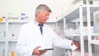 Pharmacist standing behind a hospital counter