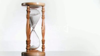 Sand running out in super slow motion in hourglass