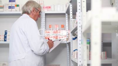 Pharmacist standing behind a hospital counter