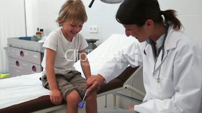 Doctor testing reaction of a child leg