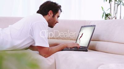 Videos of people looking at charts a laptop in a living room