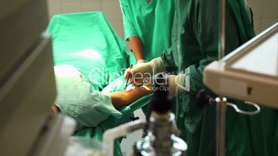 Close up of a hand using a scalpel to cut the skin of a patient
