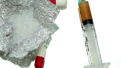 Pills cocaine and a syringe thrown