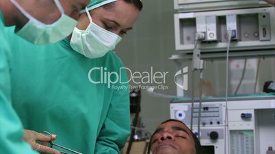 Serious doctors operating a patient