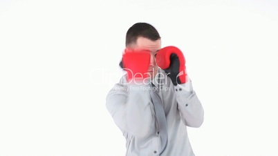 Businessman boxing with red gloves