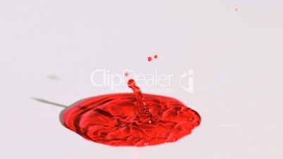 Red liquid splashing in super slow motion