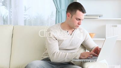 Man using his laptop placed on the armrest