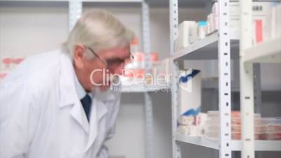 Pharmacist writing on his clipboard