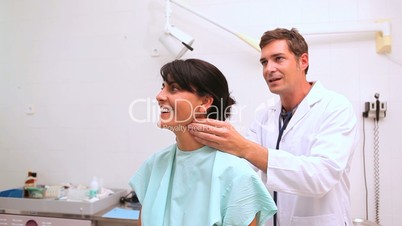 Doctor auscultating the neck of a patient