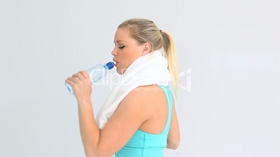 Woman drinking water after running