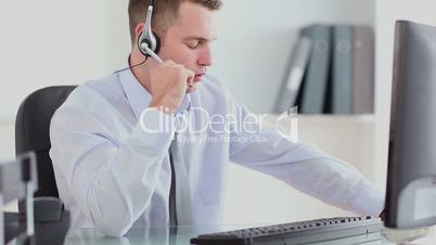Man in suit using a headset