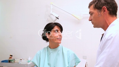 Woman patient being auscultated by a doctor