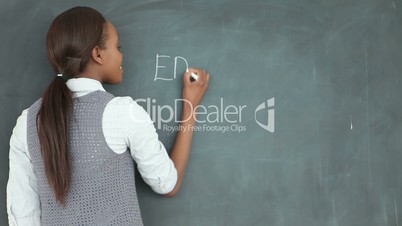 Video of a teacher looking at the blackboard