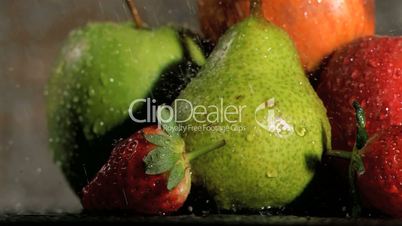 Rain falling in super slow motion on fruits