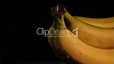 Rain falling in super slow motion on bananas