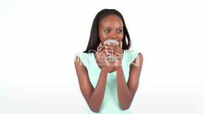 Woman smiling as she drinks from a cup