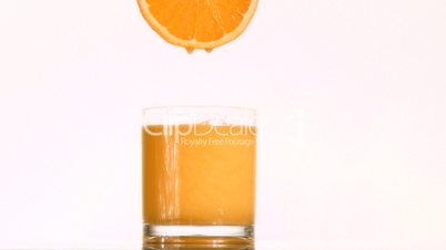 Drops of orange juice in super slow motion dropping