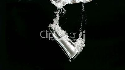 Salt shaker falling in super slow motion in water