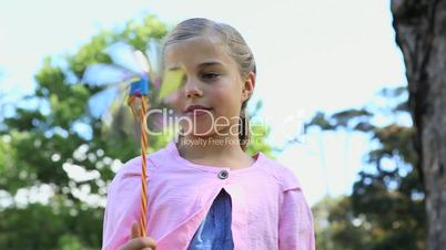 Girl looking at a pinwheel