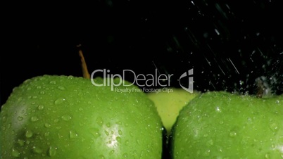 Apples watered in super slow motion and close-up