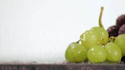 Colorful grapes in super slow motion being soaked