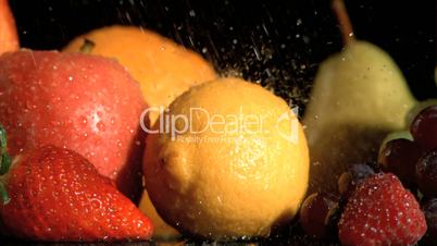 Drops falling in super slow motion on fruits