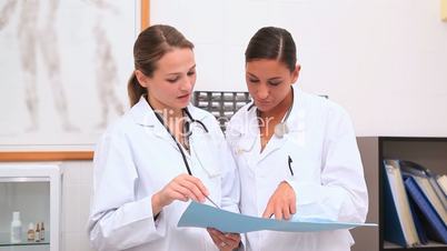 Doctors looking at a folder