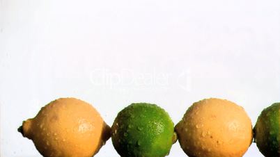 Limes and lemons in super slow motion being wet