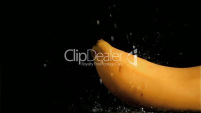Delicious banana in super slow motion being soaked