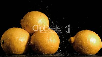Delightful lemons in super slow motion receiving water