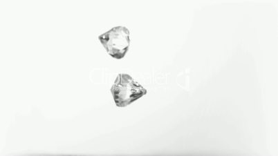 Two big diamonds falling in super slow motion