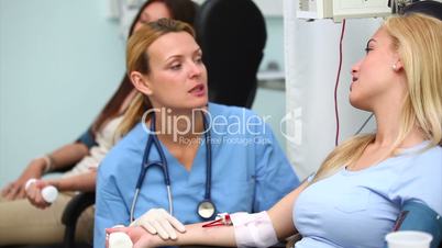 Nurse checking the monitor of a patient