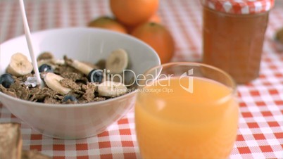 Milk poured in super slow motion in a cereals bowl