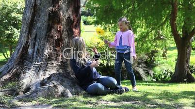 Girl giving a flower to her mother